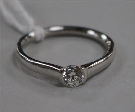 A modern 18ct white gold and solitaire diamond ring, size O.